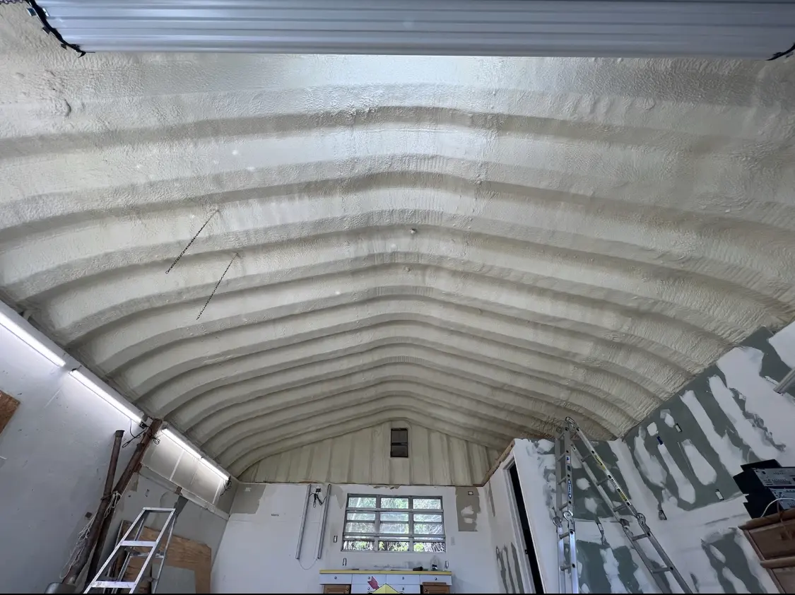 Spray polyurethane foam applied to the underside of a metal roof deck in Holmdel